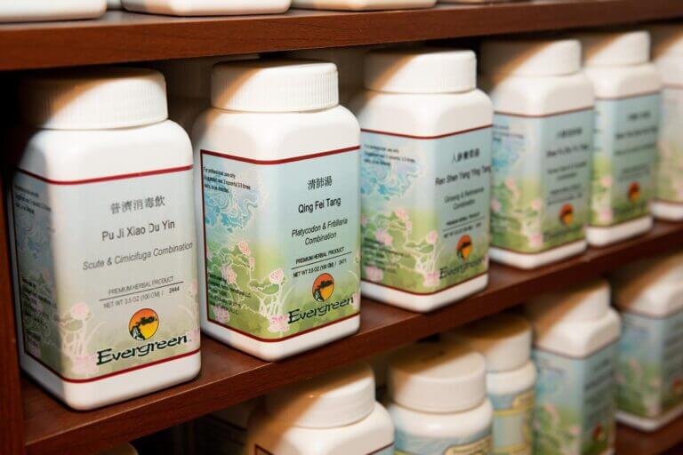 Bottles of Chinese herbs used in custom blended herbal formulas for IBS